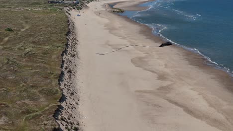 overhead birds eye drone aerial view kite flying over north norfolk uk coast