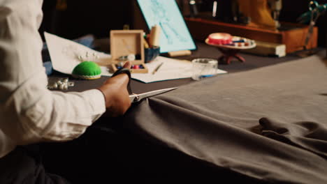 african american pupil cutting fabric