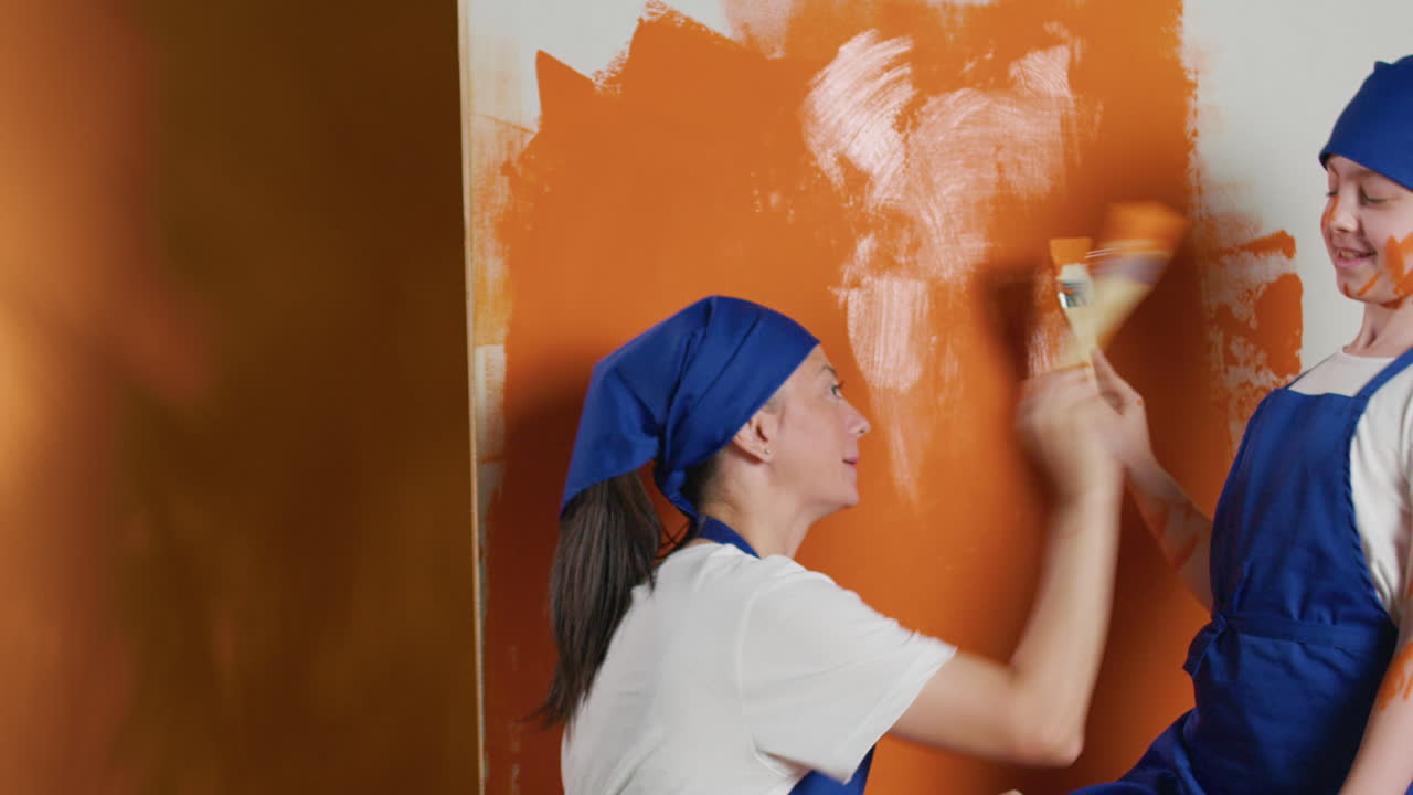 Mother and Daughter Painting a Wall