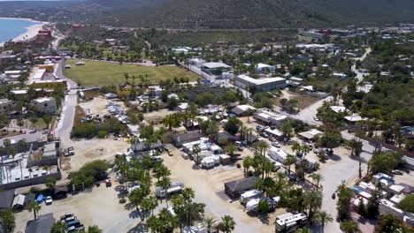 Baja,-Mexico---Tropical-Beachside-Coastal-Town-in-Touristic-Part-of-California-Sur,-Aerial-Drone-Flyover