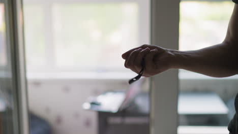 happy owner hand throws up and catches key in apartment