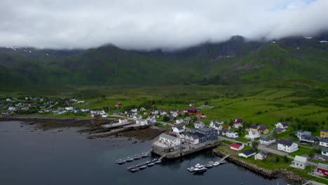 flying backwards over mefjordvar on a overcast day, senja island, northern norway