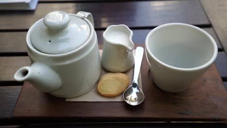 white tea set in a wooden table ready to be served