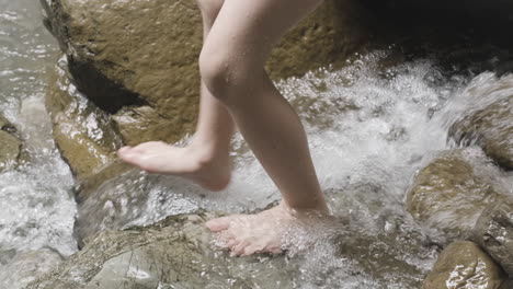 child walking through a stream