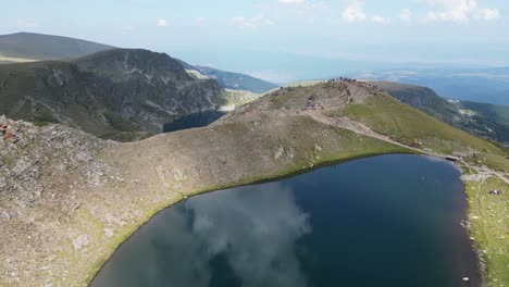 tourist people at seven rila lakes hike trail viewpoint in bulgaria - aerial 4k