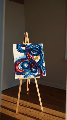 abstract painting on easel in a room