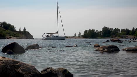 wide landscape shot showing a costal bay with boats passing, bright sunny day