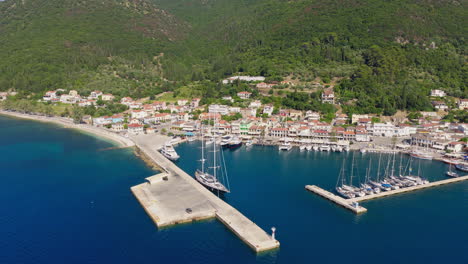 sami town and port with boats and yachts, surrounded by hills covered in pine trees, kefalonia island, aerial view