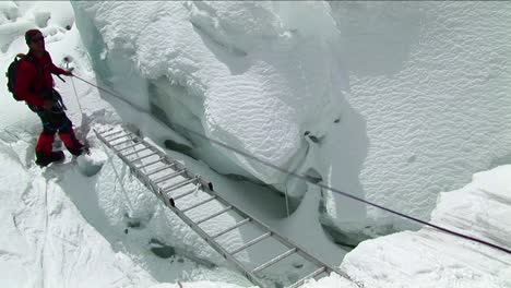 climber crossing short ladder using ropes