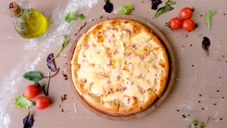 pizza with bacon and cheese on wooden board on the table.