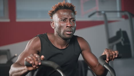 man working out on a rowing machine in a gym