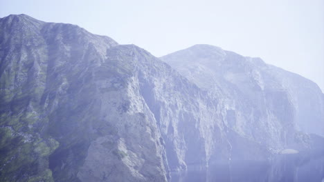 majestic mountains rising above a serene lake under a clear sky