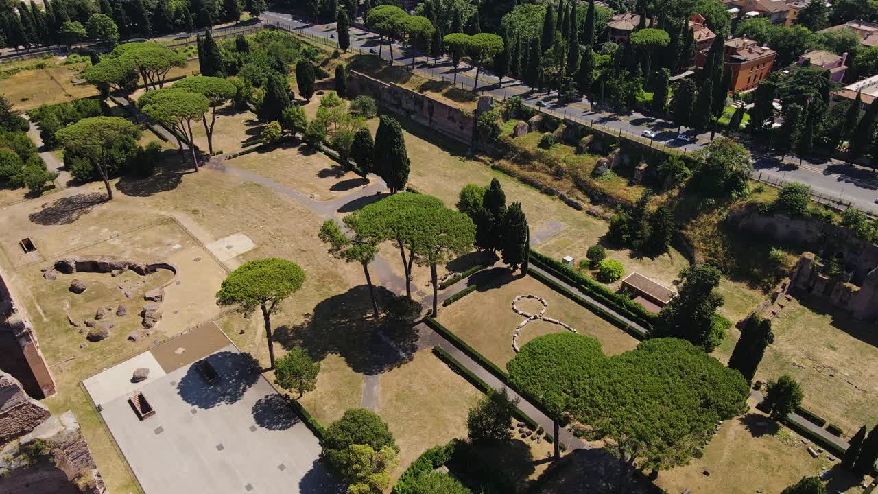 Green pine trees and Roman ruins bask in summer light near Baths of Caracalla