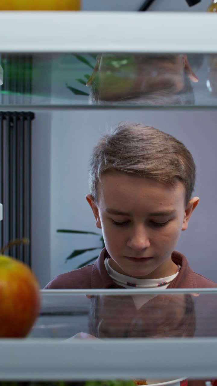 Child eating fried chicken from refrigerator