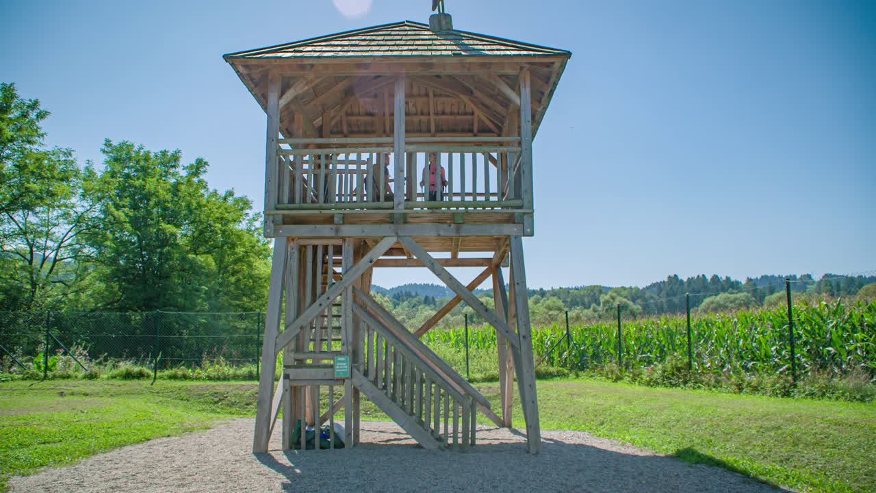 Hikers friends walking at wooden observation tower. Radlje ob Dravi. Slow motion