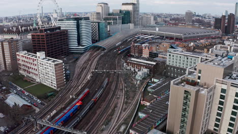 stationary drone shot of trains pulling into london waterloo station