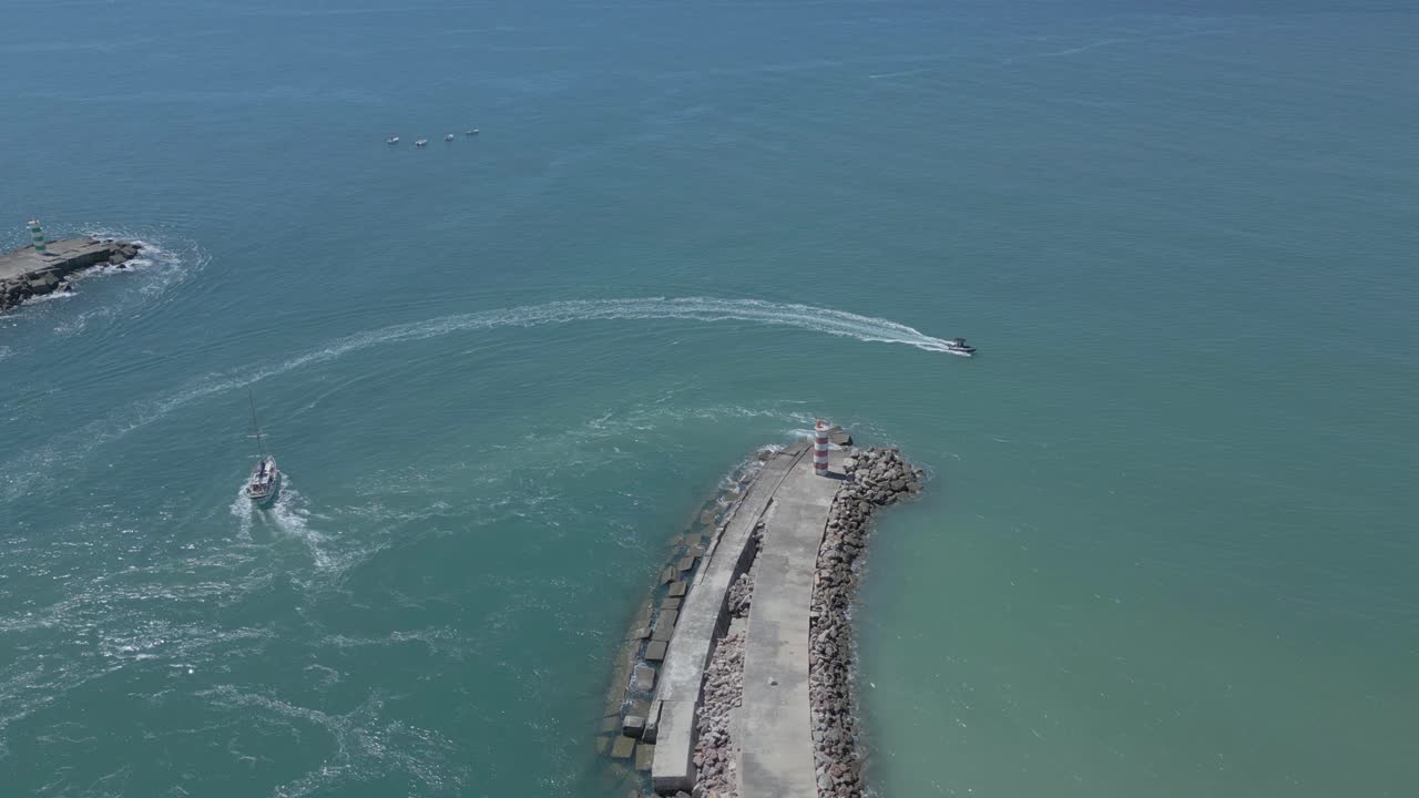 Aerial view of two boats circling a quay