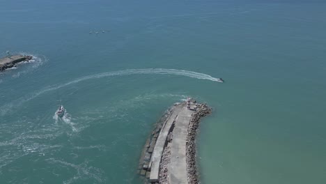 vista aérea de dos barcos dando vueltas alrededor de un muelle