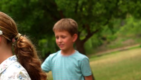 Kids-standing-in-park-with-hula-hoop