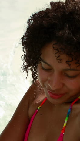 gorgeous woman relaxing in hot tub and smiling