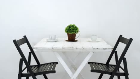 Chairs-and-table-arranged-against-wall-4k