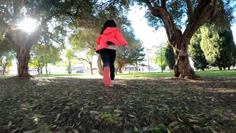 little girl runs at the park in slow motion