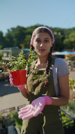 woman holding a plant in a pot