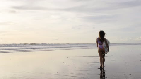 young woman with surfboard