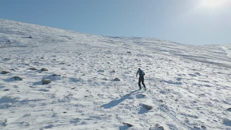 strong athlete running uphill on snow