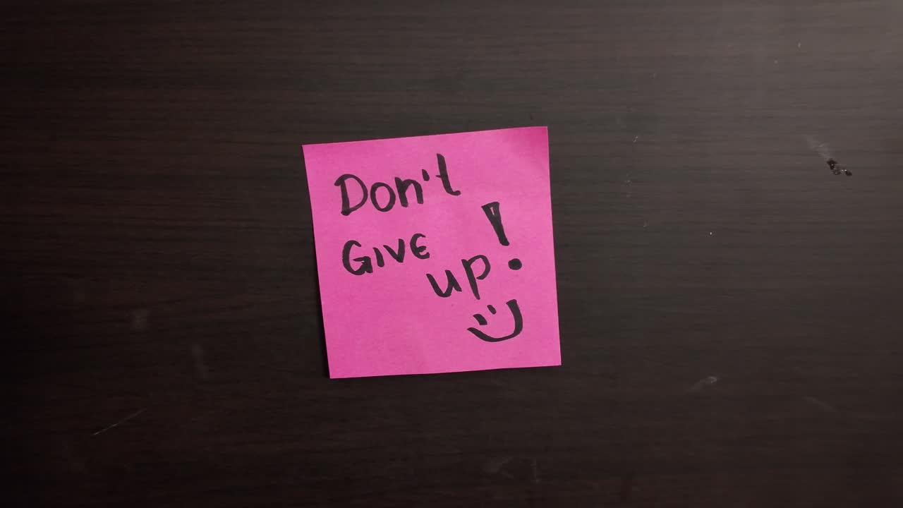 Pink sticky note on the door with a message dont give up