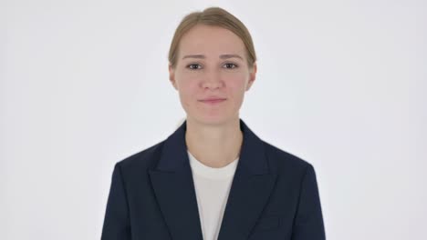 young businesswoman praying with fingers crossed on white background