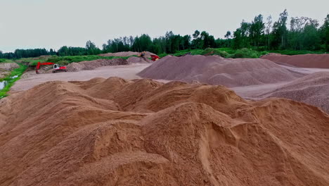 aerial flight over sand mining field with conveyor and excavators in rural area