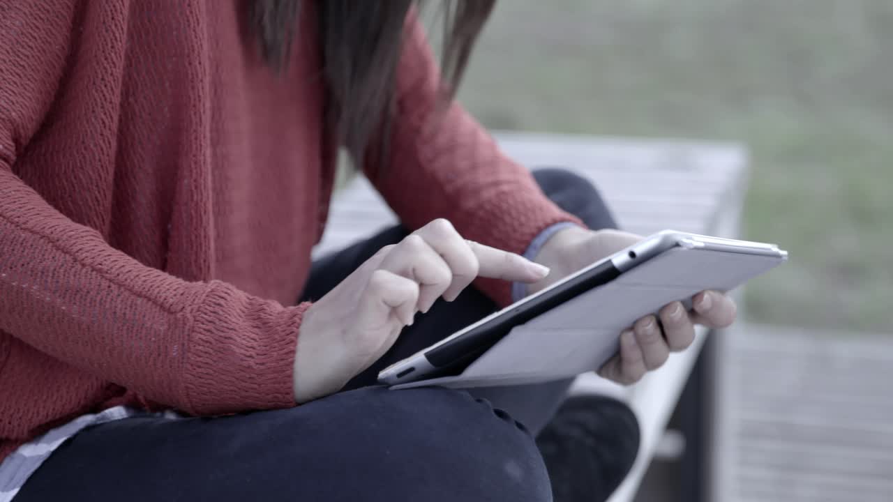 Woman Using Digital Tablet Outdoors, Typing on Screen