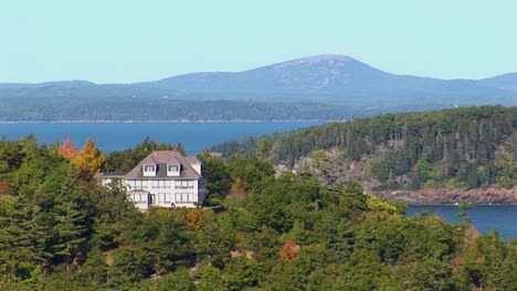 a house and islands are seen in the distance of a forest in bar harbor maine