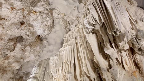 cave limestone underground with white stalactites and stalagmites