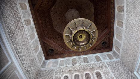 chandelier, wooden islamic design ceiling in muslim arabic riad, morocco