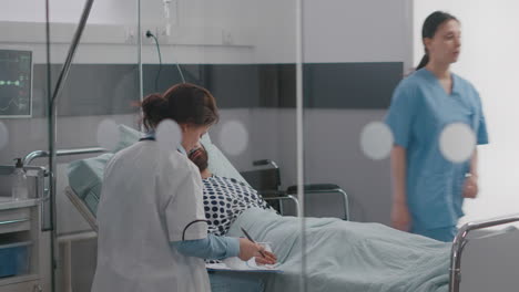 practitioner specialist doctor writing sickness treatment on clipboard