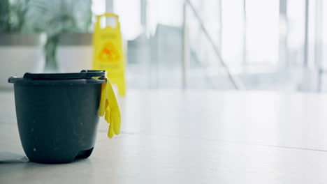 cleaning, products and bucket on floor of office