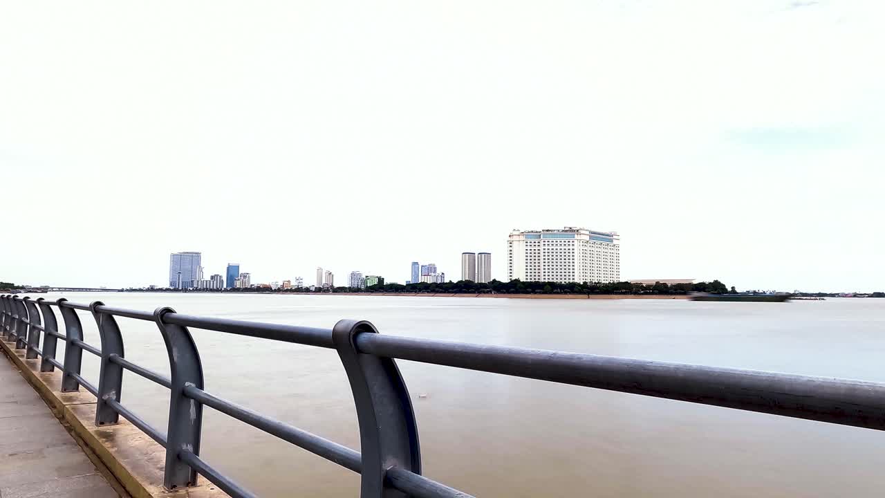 Waterfront of Phnom Penh capital of Cambodia Mekong River flows past city skyline time lapse