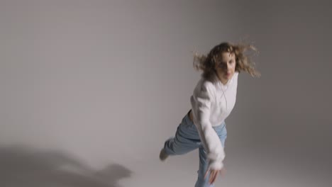 Full-Length-Studio-Shot-Of-Young-Woman-Having-Fun-Dancing-Against-Grey-Background-5