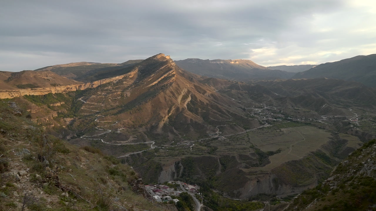 Sunlit Ridge Overlooking Village Below, Golden Hour Light Washes Terraced Slopes And Winding Road, Dramatic. Creative
