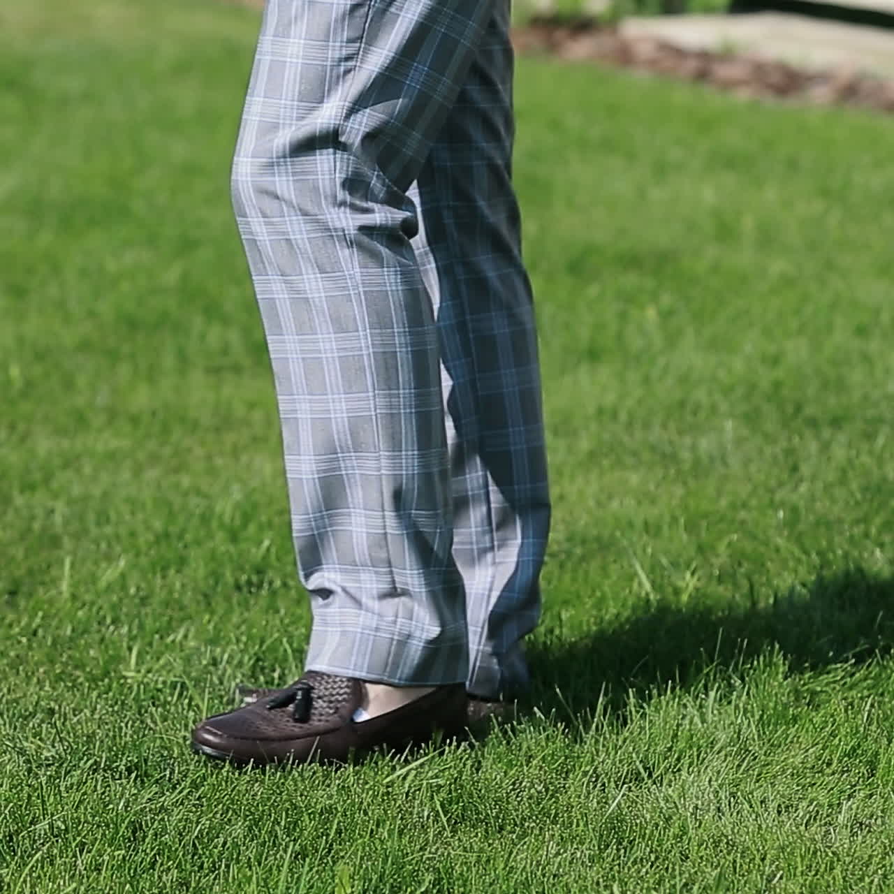 Elegant Male Shoes walking on green park grass. Square video