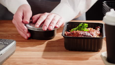 restaurant worker preparing takeout orders