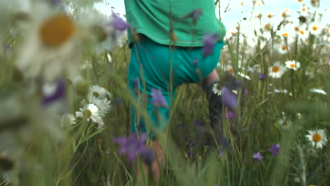 child running through a field of flowers