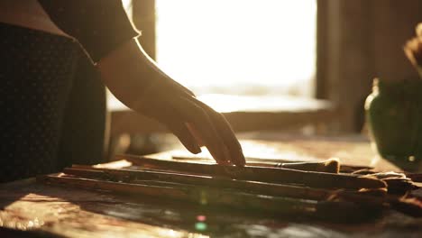 close up footage of accurately manicured female hand choosing brush from a row on the table. slow motion.