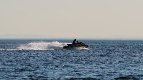 person riding jetski on calm ocean waters