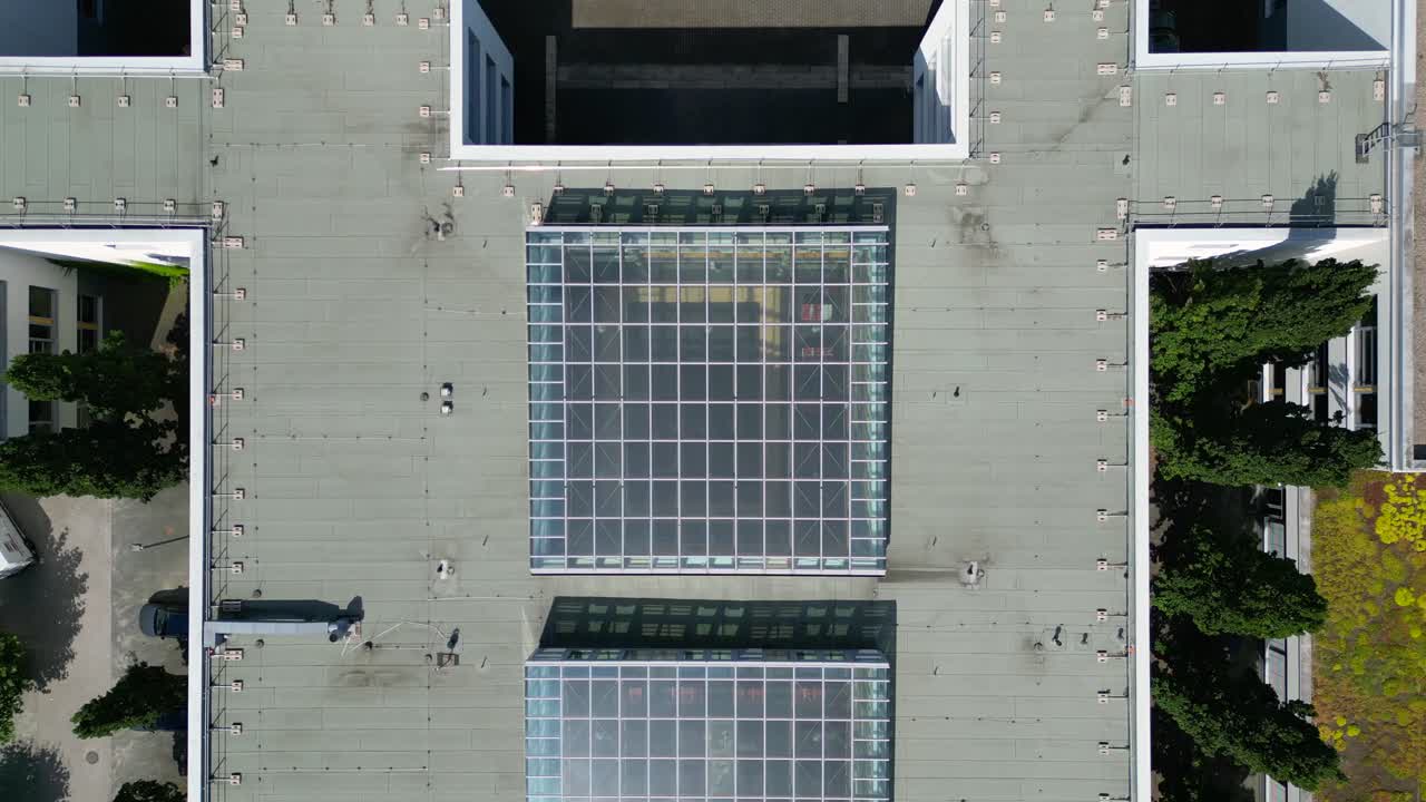 Hennigsdorf High School showcasing its modern architecture, sports facilities, parking area, surrounding urban landscape