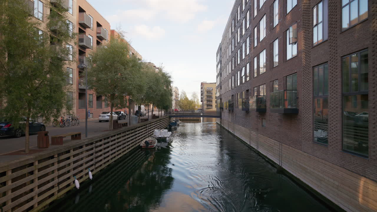 Copenhagen, Denmark - October 24, 2024: Man kayaking on a canal in the Teglholmen island in the South Harbour of the city