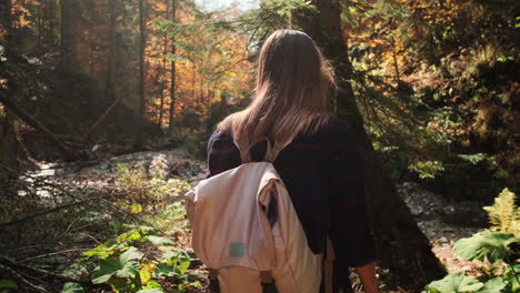 woman hiking in autumn forest