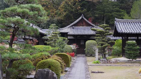 traditional japanese temple surrounded by manicured gardens, serene setting